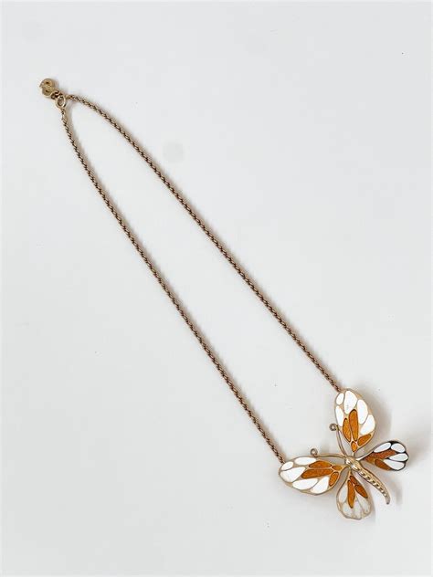 dior butterfly necklace|Dior pearl necklace.